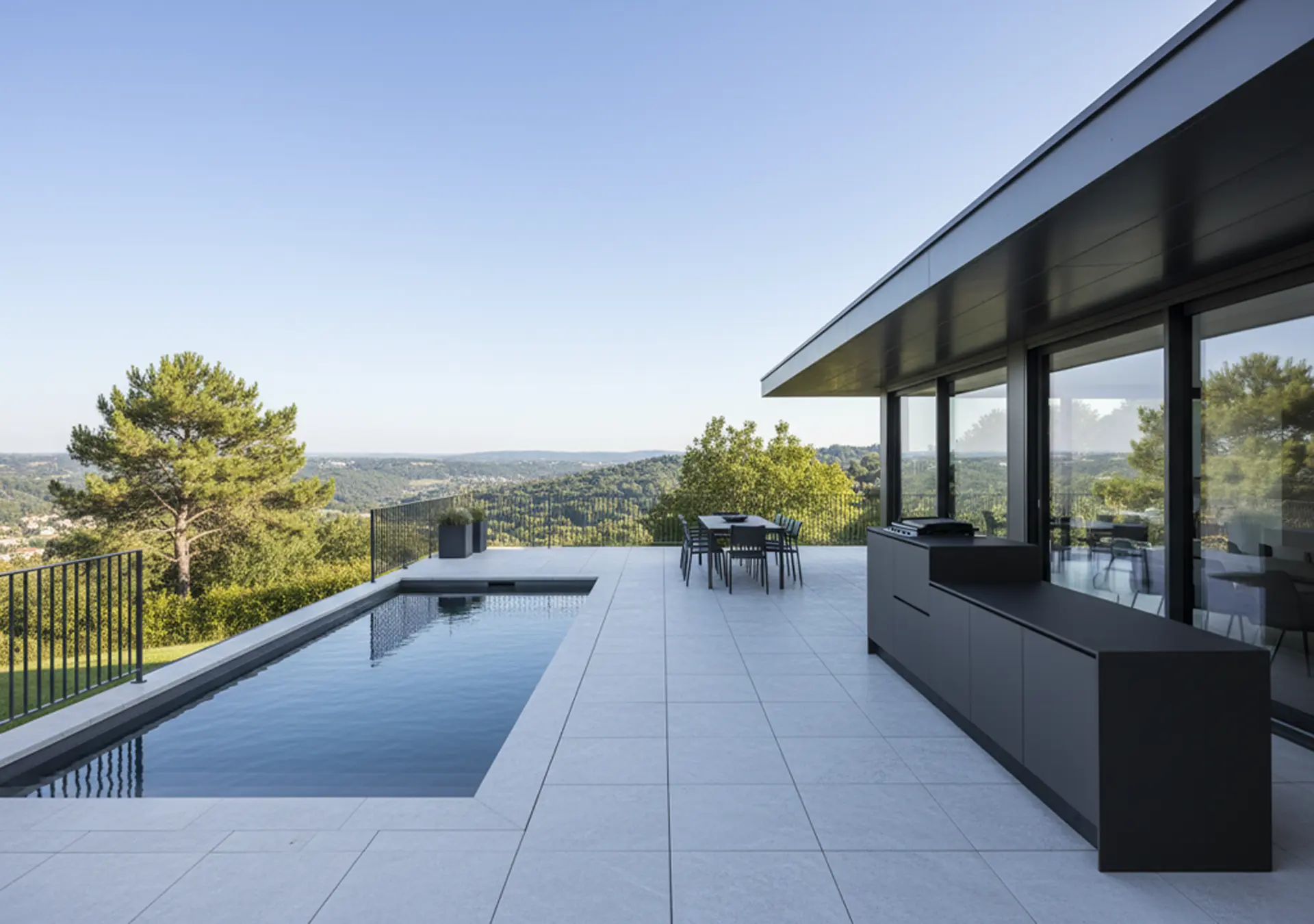 cuisine extérieure été cuisinedété avec plancha encastré intégré terrasse Lyon Rhone table à manger chaises piscine vue coline
